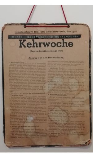 Dieses Kehrwochenschild enthält einen Auszug aus der Hausordnung. Neben den Erläuterungen zur Kehrwoche werden noch andere Hausregeln aufgeführt, wie etwa zum Schließen der Haustür und zur Haltung von Haustieren. (Foto: Stephanie Raunegger)